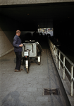 849777 Afbeelding van een medewerker van de gemeentelijke reinigingsdienst (?) met een bakfiets in de Leidseveertunnel ...